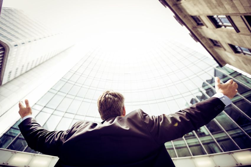 Benefits - low-angle photography of man in the middle of buidligns