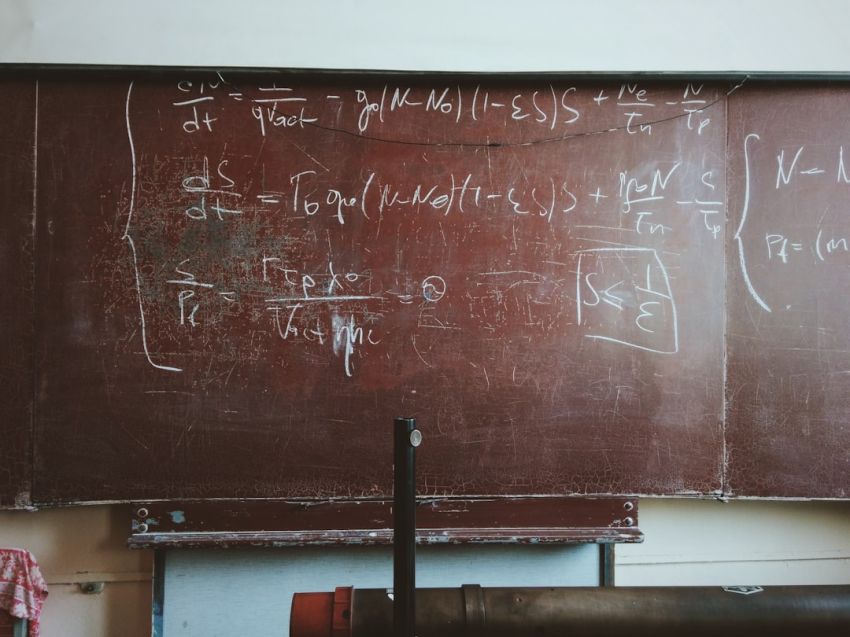 Formula - written equations on brown wooden board