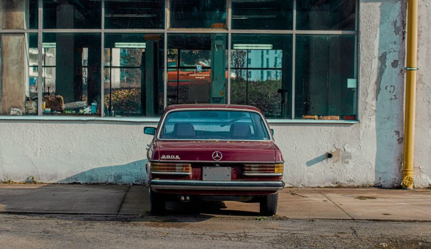 Accuracy - red car parked beside building during daytime