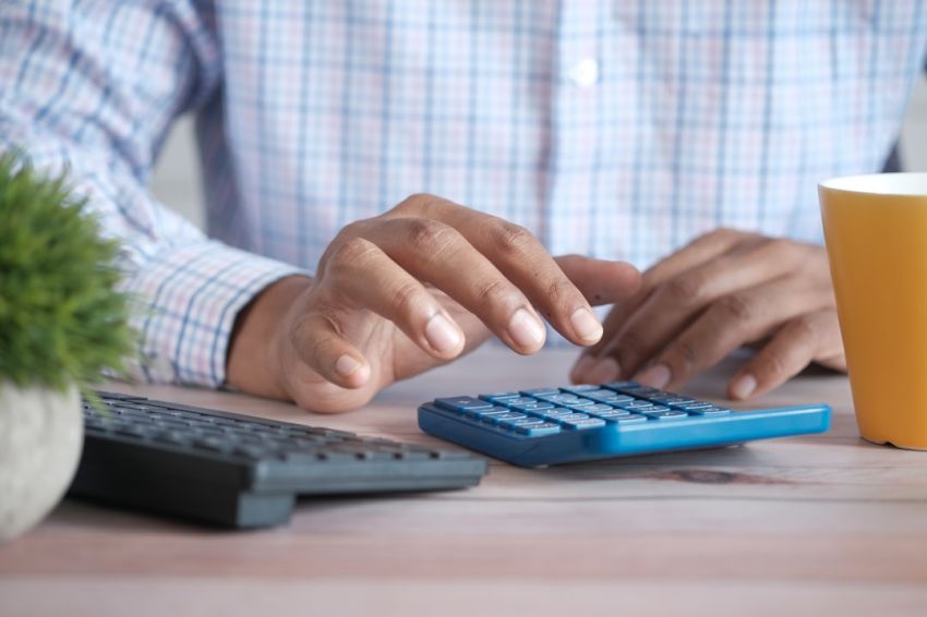 Calculator - person using black computer keyboard