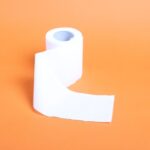 Uses - a roll of toilet paper on an orange background