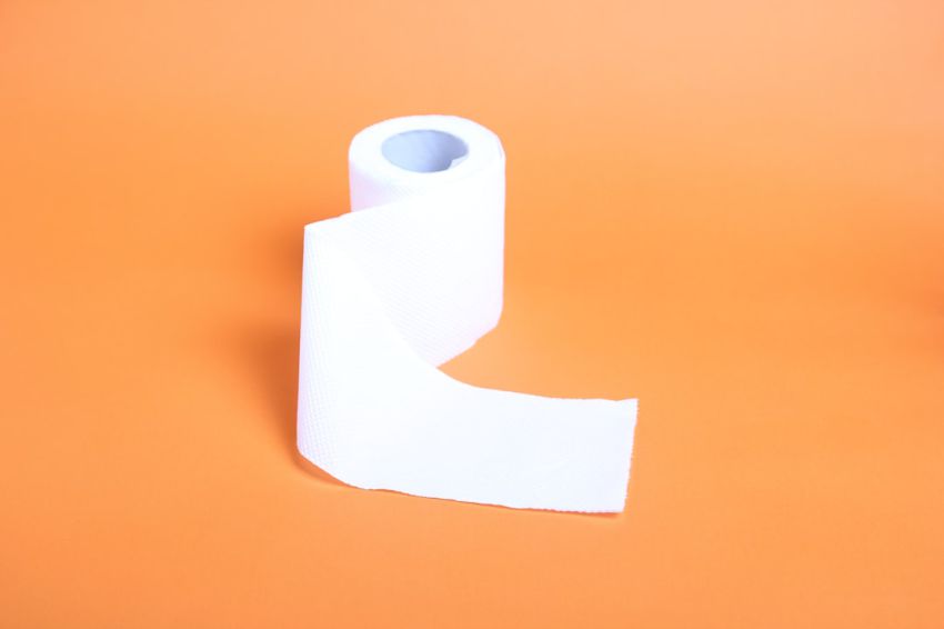 Uses - a roll of toilet paper on an orange background