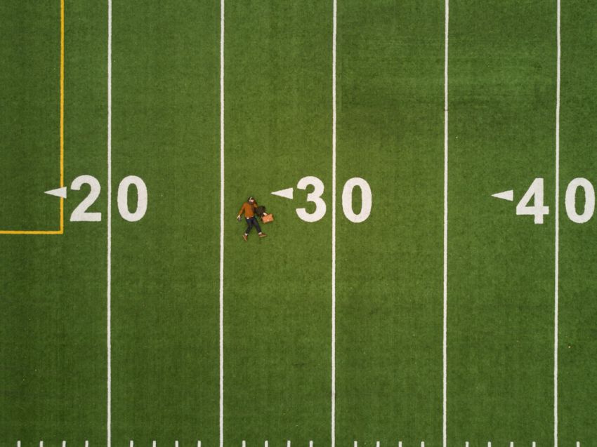 Age - man lying on 30 yards on football field